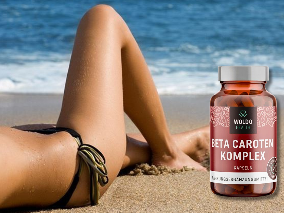 Beta carotene supplement bottle next to a woman relaxing on a sandy beach with the sea in the background.